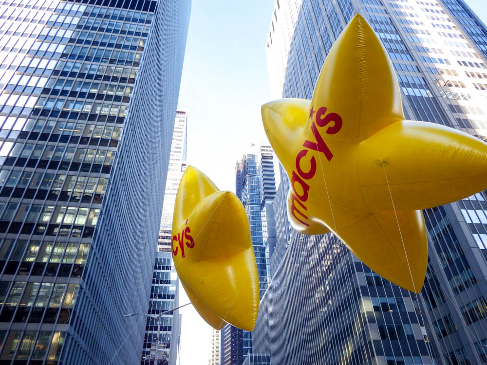 two yellow star-shaped Macy's balloons