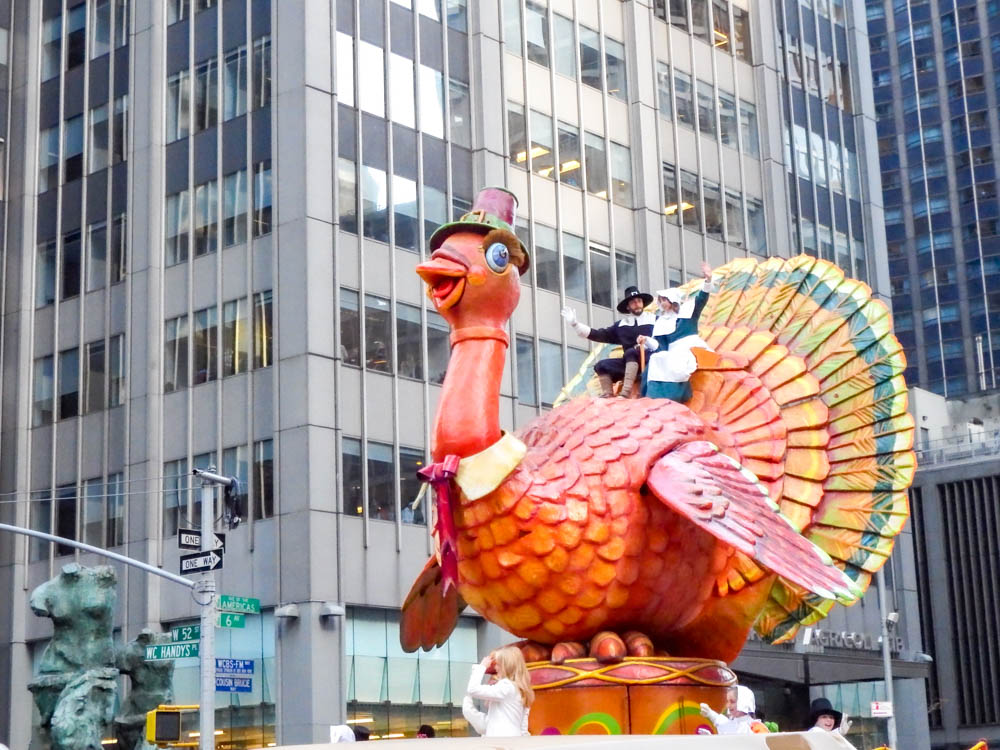 giant turkey float with pilgrims on top at the macys thanksgiving day parade