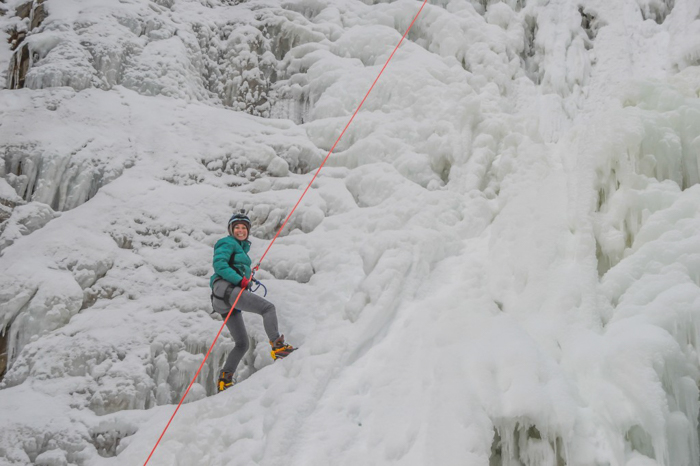 Ice Canyoning in Québec // Why You Should Be All up in This | Smiling on the frozen waterfall while ice canyoning in Québec