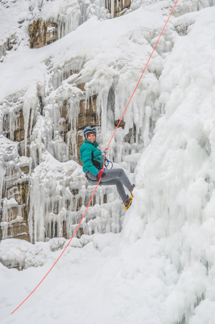 Ice Canyoning in Québec // Why You Should Be All up in This | Smiling on the frozen waterfall while ice canyoning in Québec