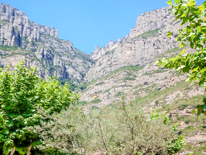 Day trip to Montserrat | 4 days in Barcelona, Spain, Catalonia | Things to do in Barcelona | What to do in Barcelona | Catholic monastery | Catalunya | 1 day in Montserrat | Serrated Mountains | looking up