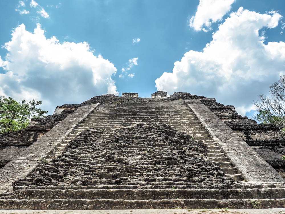 rough stone steps leading up to top of temple in front of blue sky