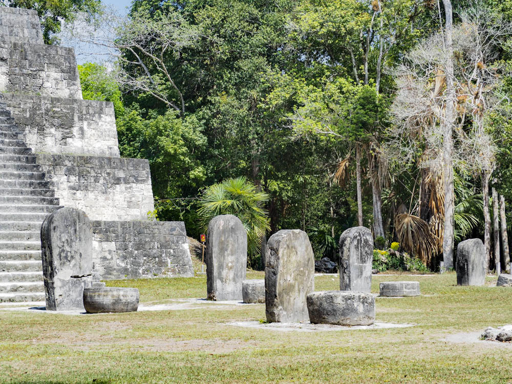 gravestone shaped stones in front of ancient temple