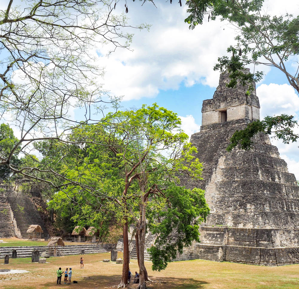 ancient temple seen through the trees on belize to tikal day trip