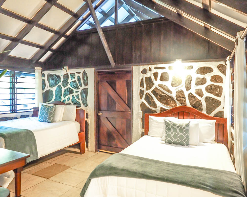 two beds inside jungle cabin in belize