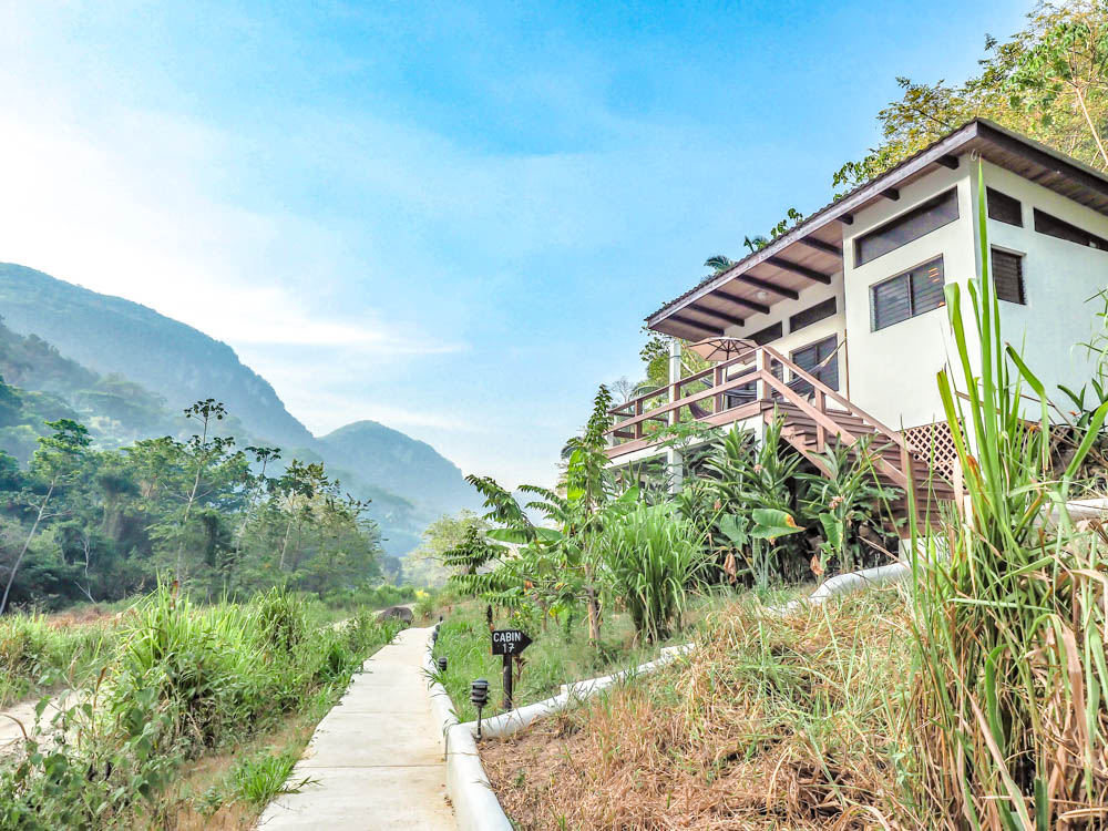 large cabin in the jungle along a path in belize