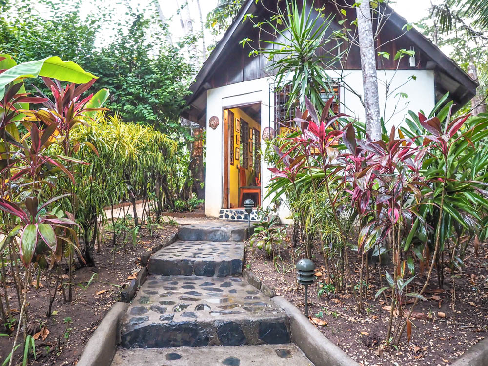 small building hidden in the jungle