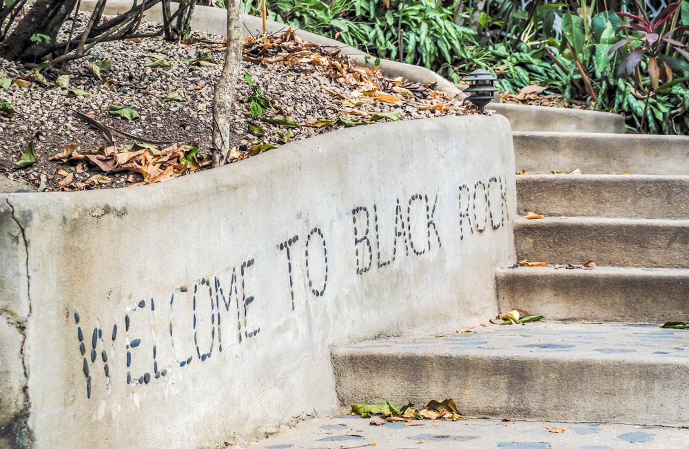 welcome to black rock written in rocks in a wall