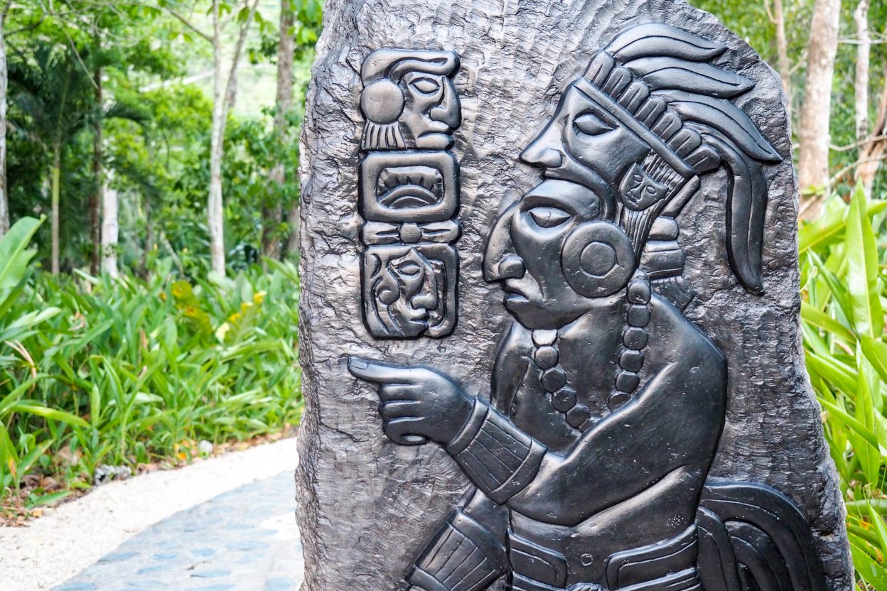 slate carving with maya figures and symbols in belize