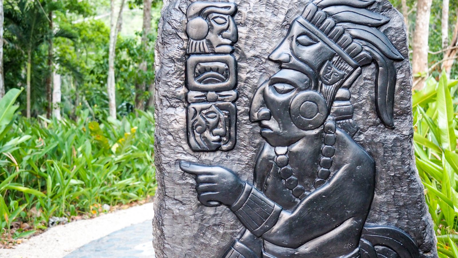 slate carving with maya figures and symbols in belize