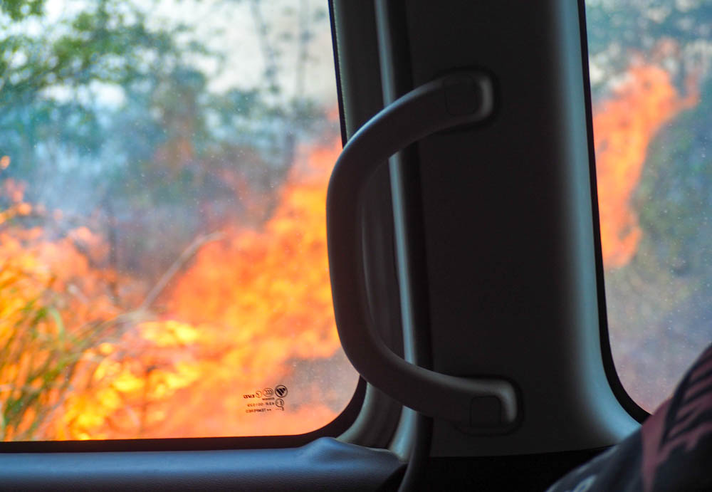 raging wildfire out a car window in belize