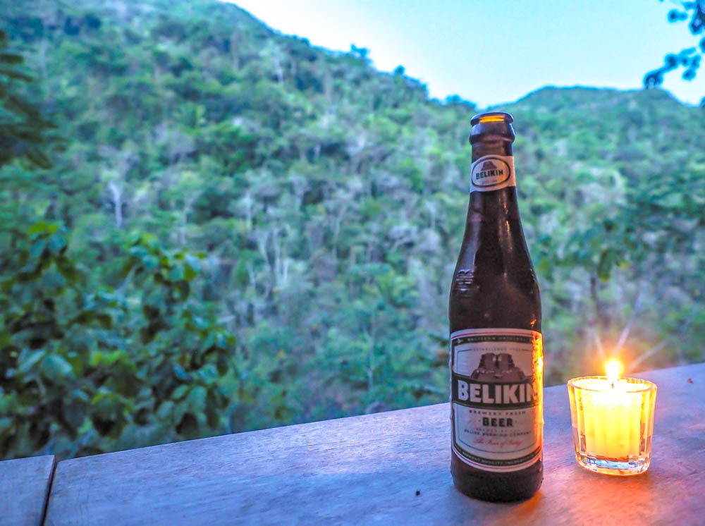 bottle of belikin beer in front of the jungle in belize