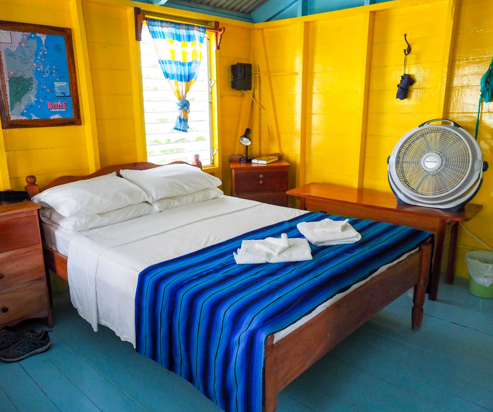 bed inside yellow and teal beach cabana