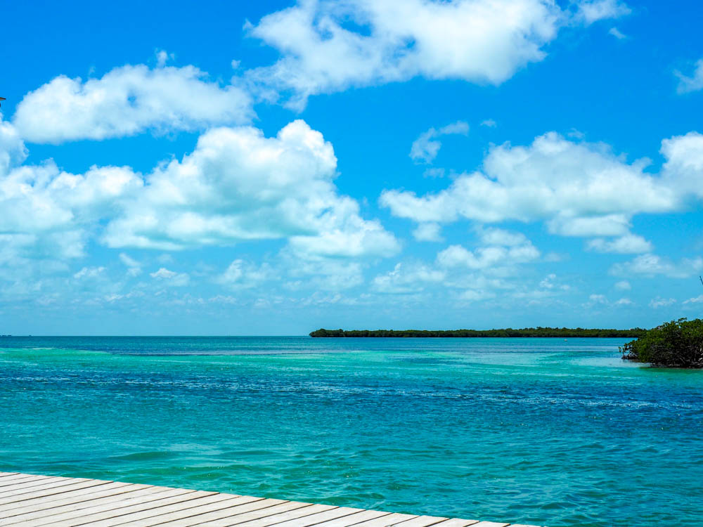 turquoise and blue ocean water next to a dock