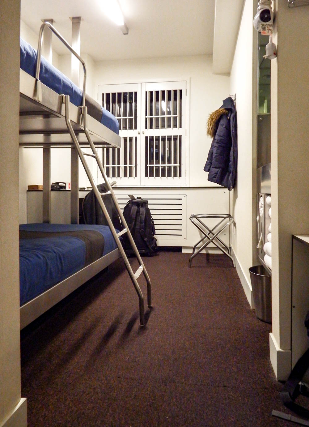 two bunk beds in a tiny hotel room