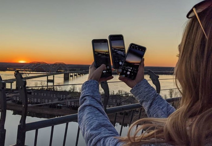 Taking pictures of the Mississippi River bridge from the Lookout at the Pyramind | 200 things to do in Memphis, Tennessee for first-time visitors - a local's guide #memphis #tennessee #mississippiriver #sunset #goldenhour #traveltips