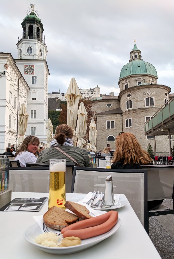 How to Squeeze in a Day Trip to Salzburg from Munich | Austria to Germany | Sound of music, mozart, castle, brewery, museums #salzburg #austria #thesoundofmusic #beer #mozart #daytrip #castle | Mozartplatz, vienna sausages