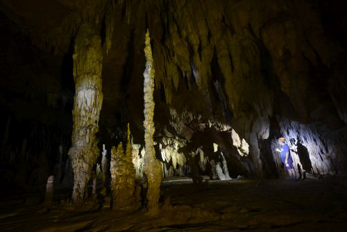 Man with flashlight in the ATM Cave / What to pack for the ATM Cave in Belize: What to wear, what shoes to wear, what to bring, and what to never, ever bring into the ATM Cave. 