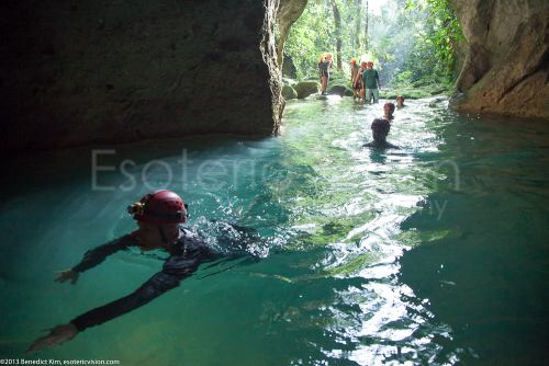 Man swimming into the ATM Cave / What to pack for the ATM Cave in Belize: What to wear, what shoes to wear, what to bring, and what to never, ever bring into the ATM Cave.