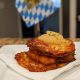 plate of potato pancakes with apple sauce in front of a bavarian flag