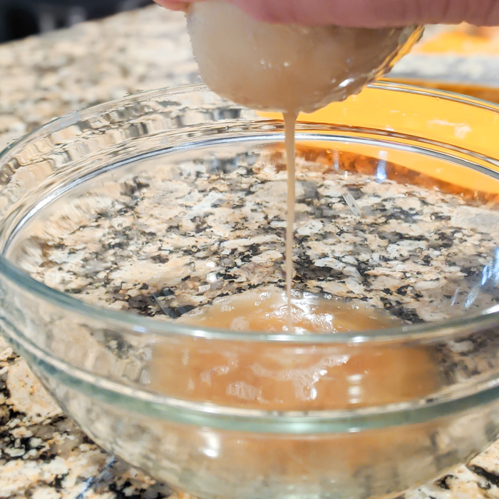 wringing the liquid out of potatoes with a tea towel