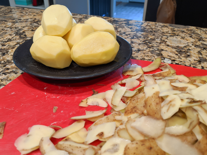 peeled potatoes on a cutting board