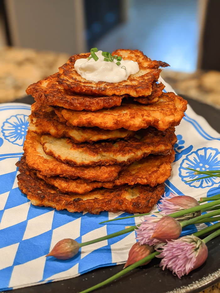 Stack of potato pancakes topped with sour cream