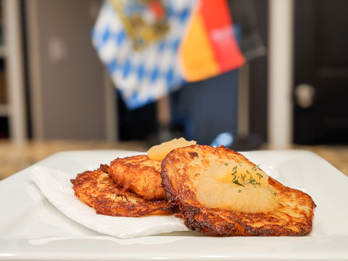 potato pancakes on a plate in front of a german flag