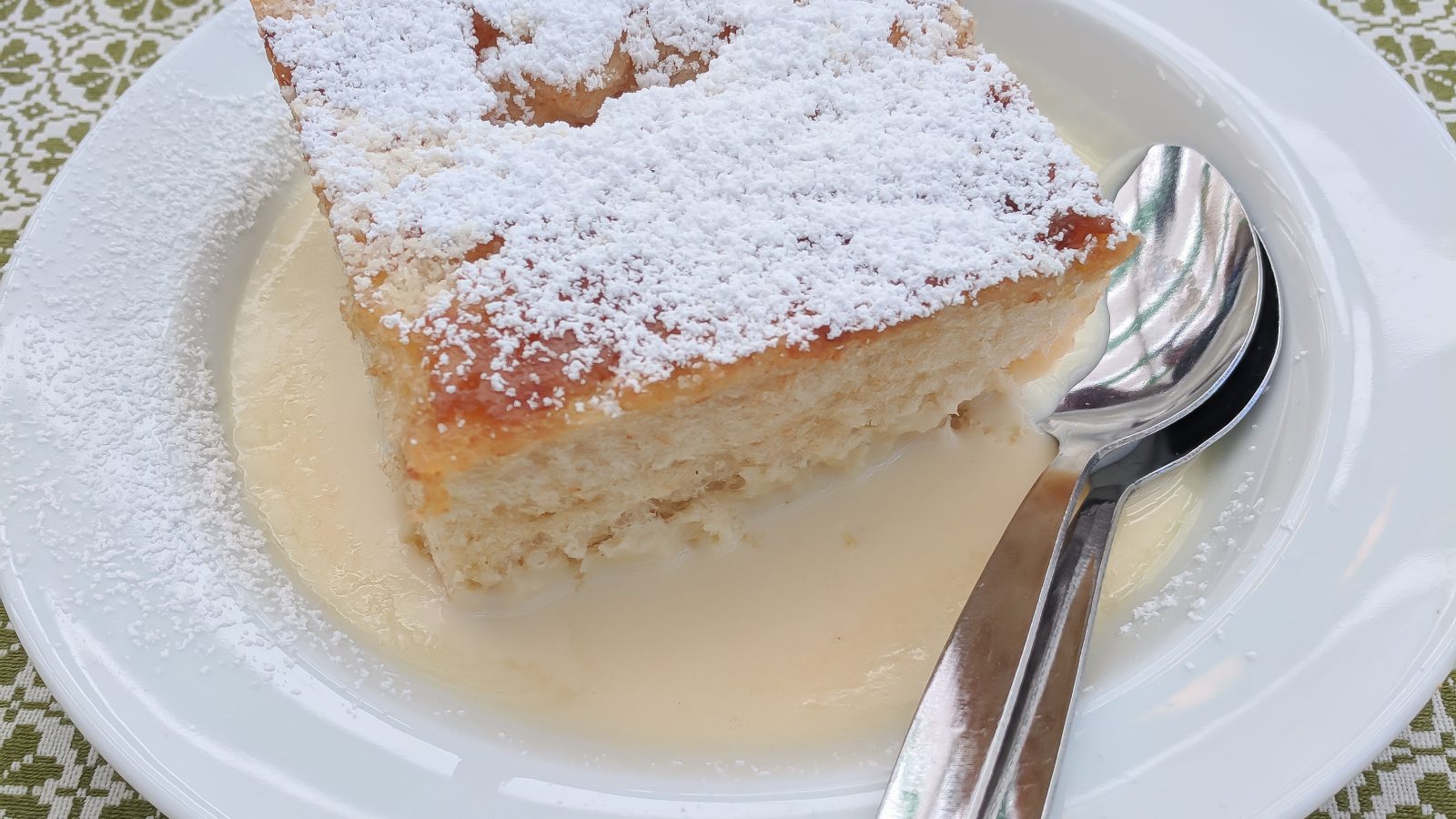 dampfnudel on a plate on a green and white table cloth