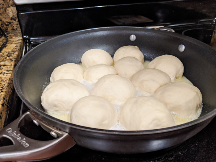 dampfnudel dumplings in a skillet on the stove