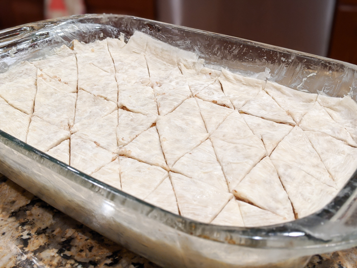 Cutting the simple honey walnut baklava recipe into shapes