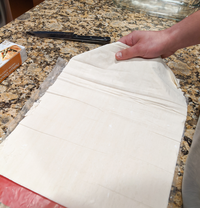 Unrolling the phyllo dough for this simple honey walnut baklava recipe