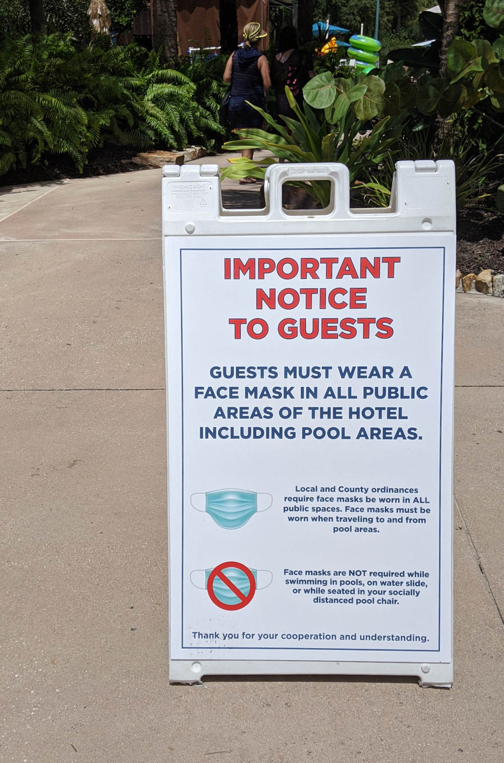 Mask mandate sign outside a pool at a Disney World resort