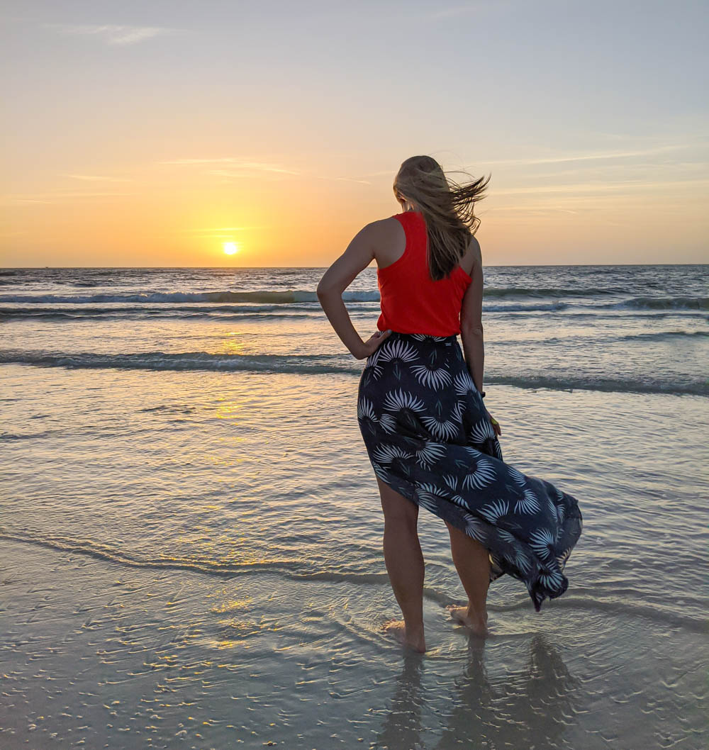 sunset over the ocean, me standing on the beach in a flowy skirt