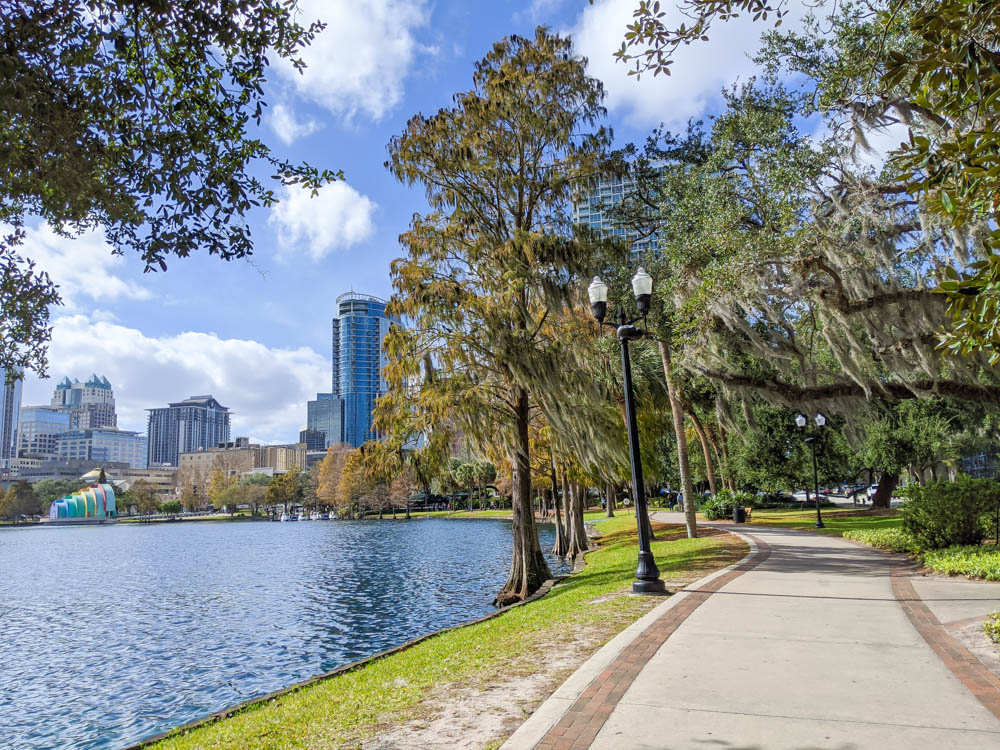 large lake surrounded by trees with Orlando skyline in the background