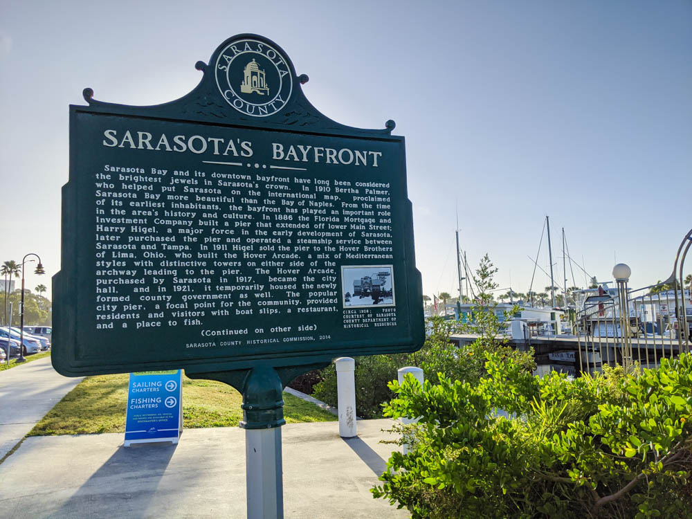 informational sign about the Sarasota bayfront in front of the marina