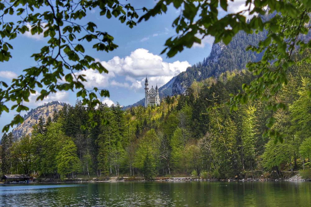 Neuschwanstein Castle and lake from a distance | Where to stay near Neuschwanstein Castle: 12 Best Hotels and Airbnbs in Hohenschwangau, Schwangau, and Füssen