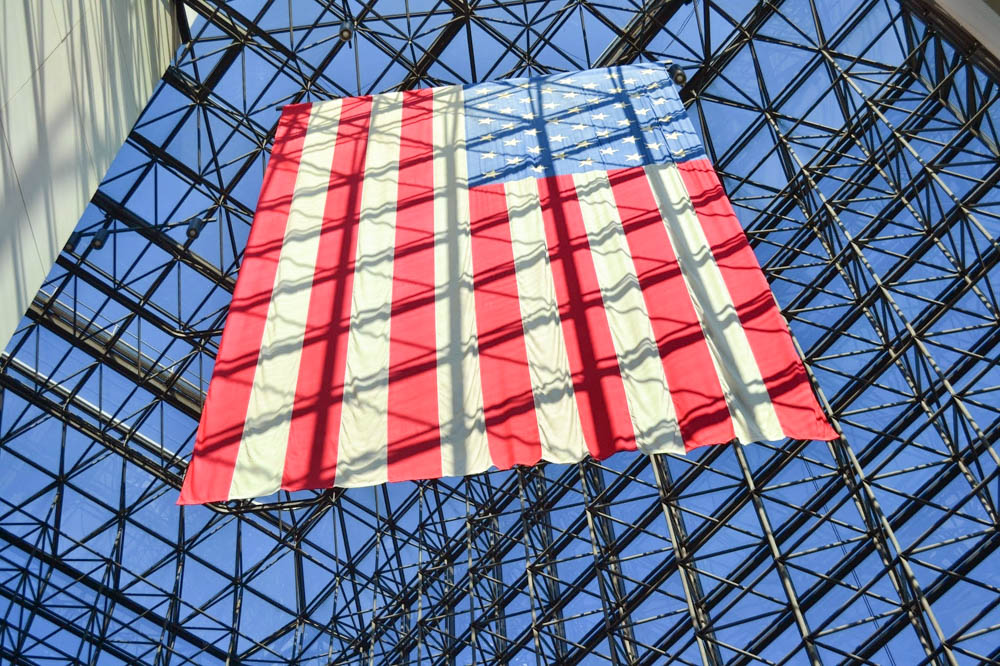 american flag hanging down in museum window