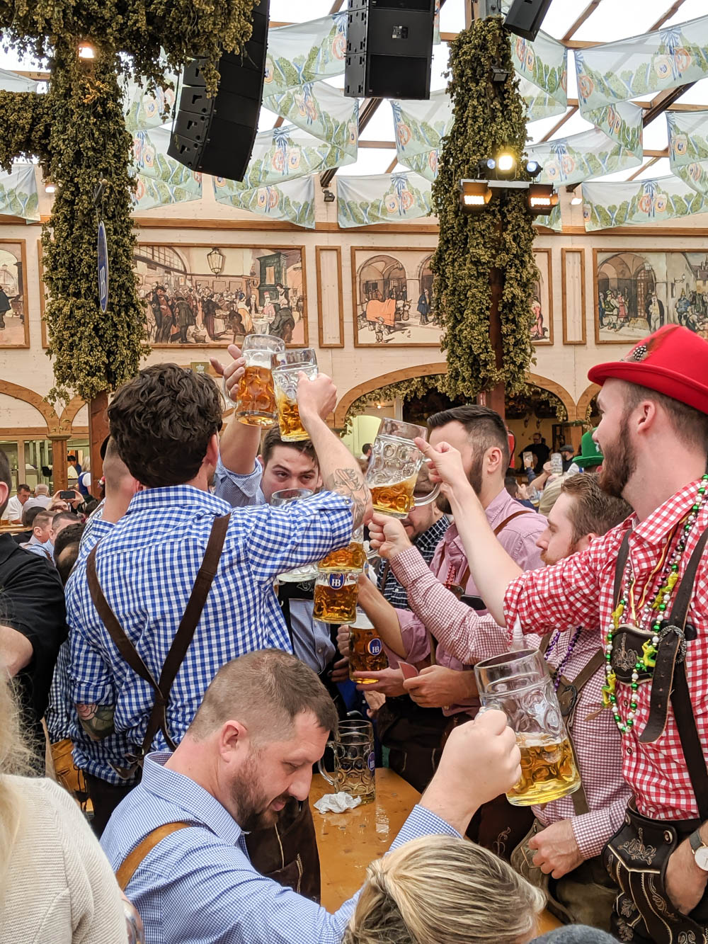 Prosting at hofbrau tent in munich | Best Oktoberfest Games for Fun & Hilarious Backyard Bierfests | Games like Hammerschlagen, Masskrugstemmen, pretzel-eating contests, stein-carrying races, and more