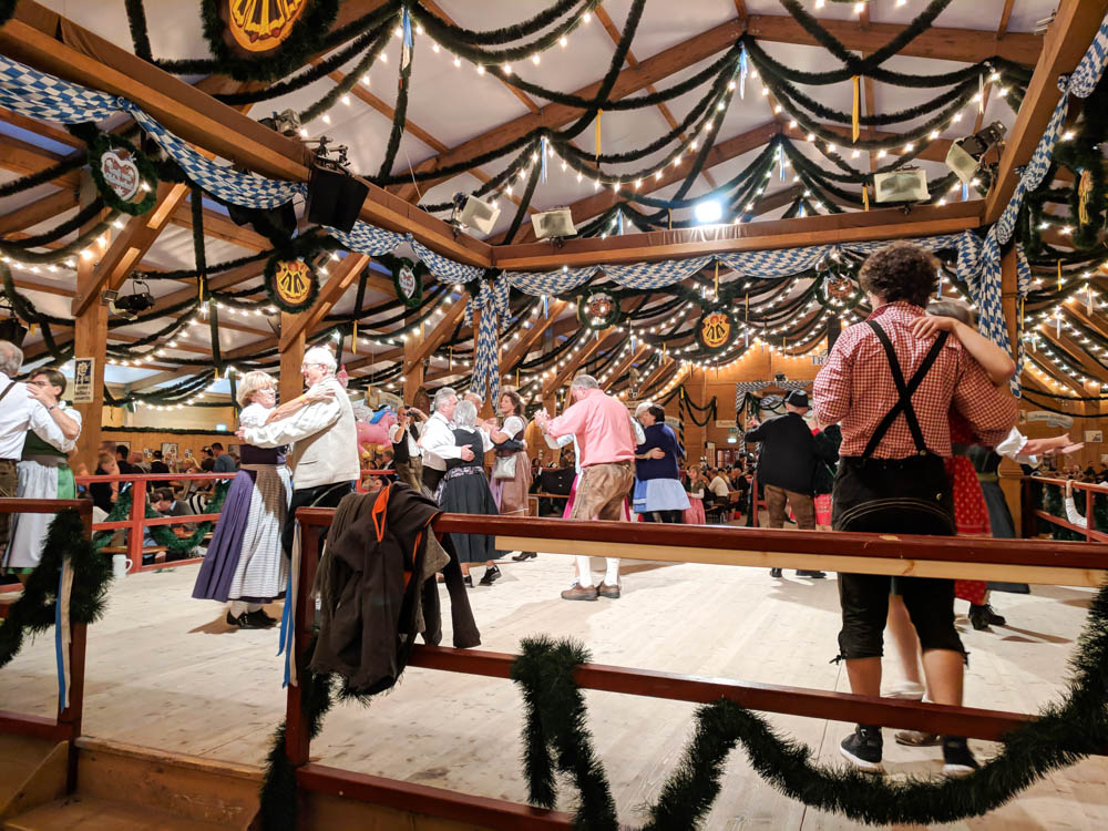 couples dancing on stage surrounded by garland and lights