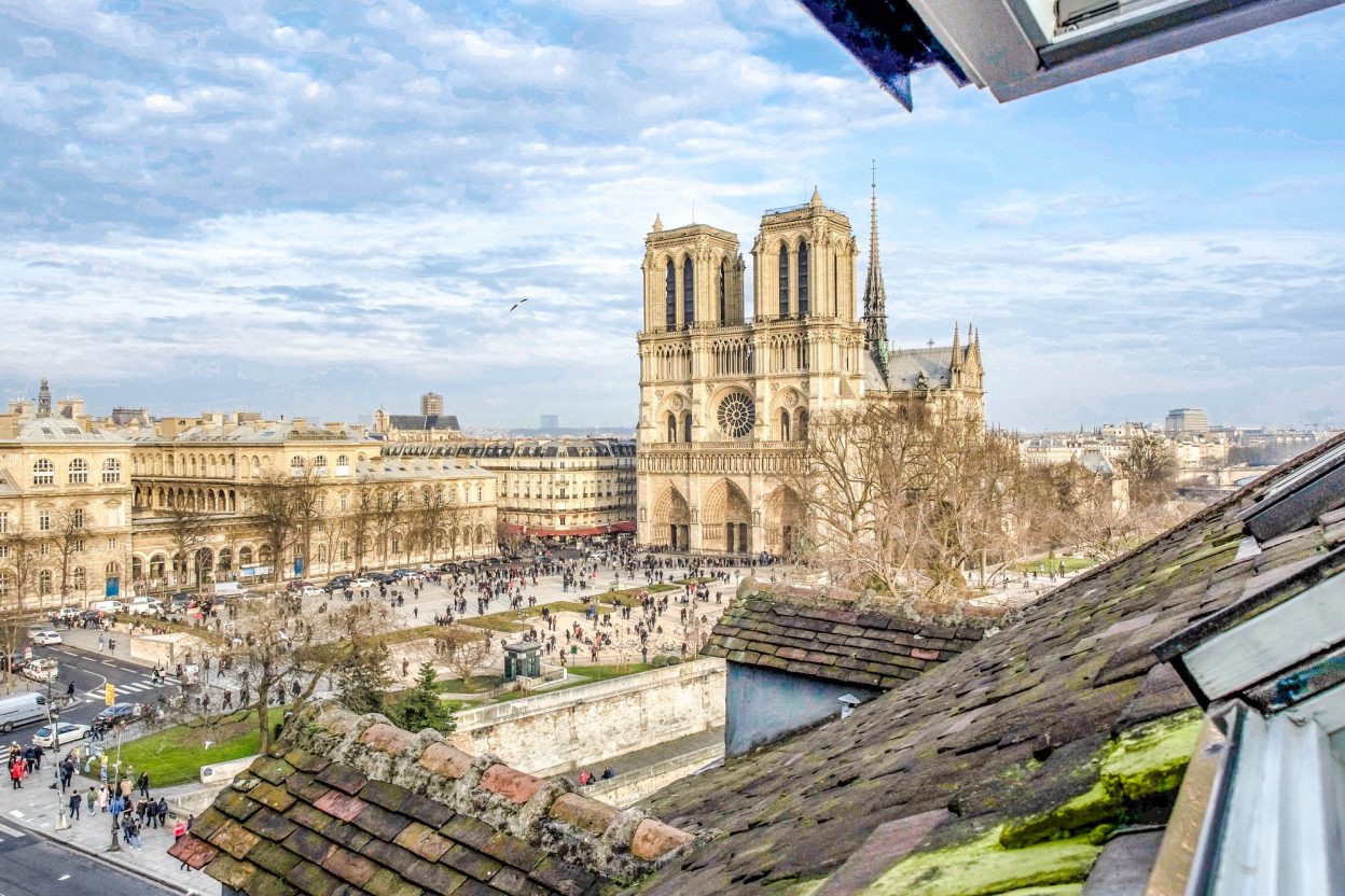 view of Notre Dame cathedral in paris from a rooftop window