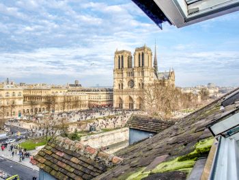 view of Notre Dame cathedral in paris from a rooftop window
