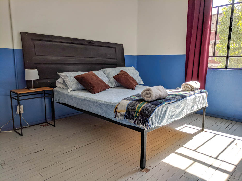 crappy bed with an old door as a headboard