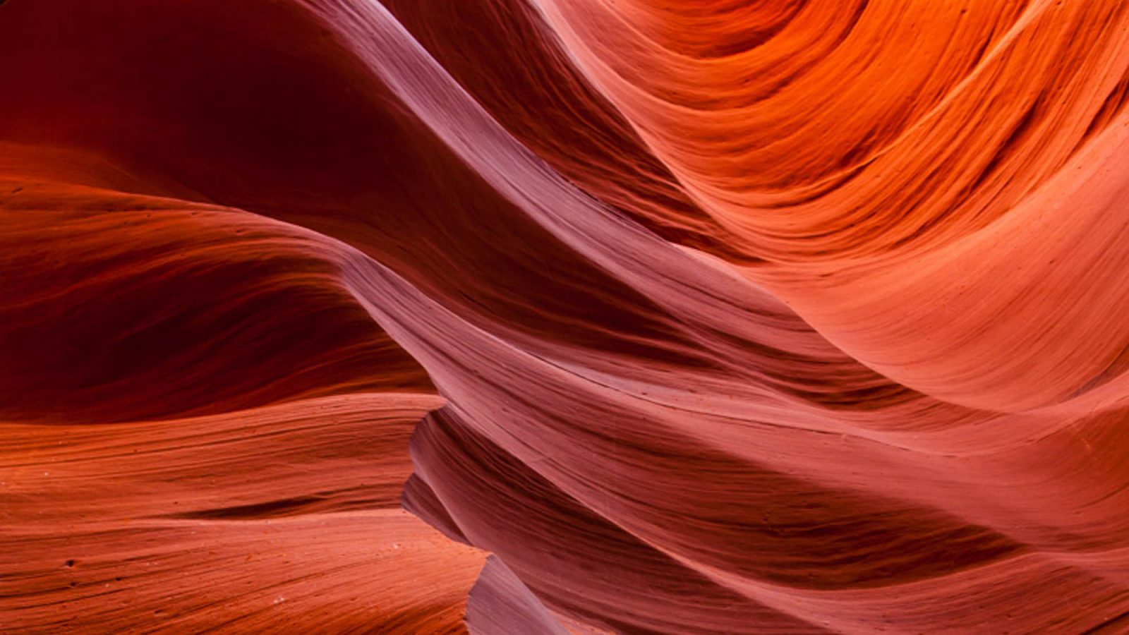 purple, orange, and red swirls of color in a slot canyon