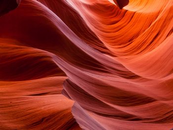 purple, orange, and red swirls of color in a slot canyon