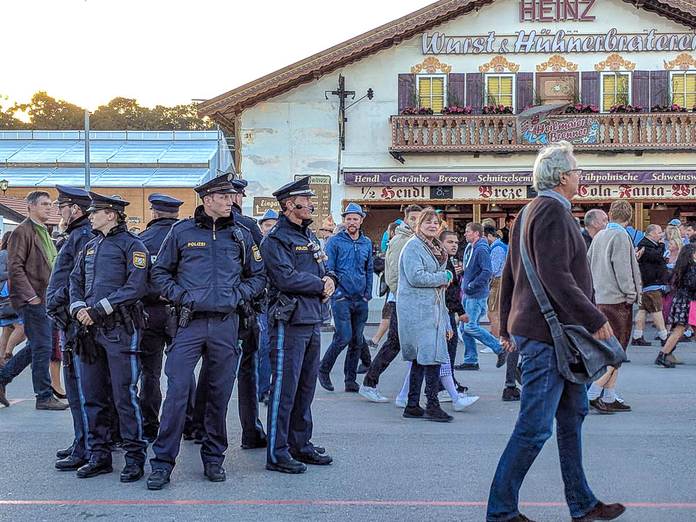 group of policemen and women gather in front of a tent at oktoberfest