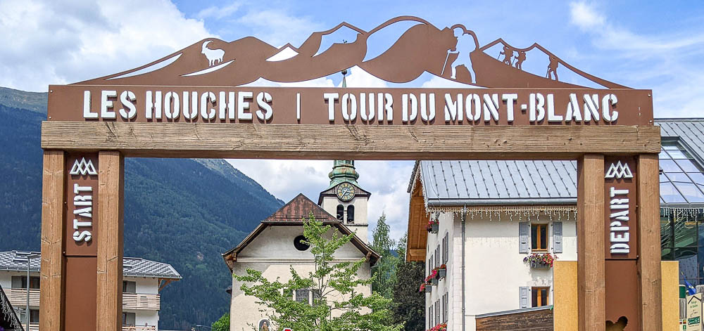 the top of the tour du mont blanc sign so you can see its artwork