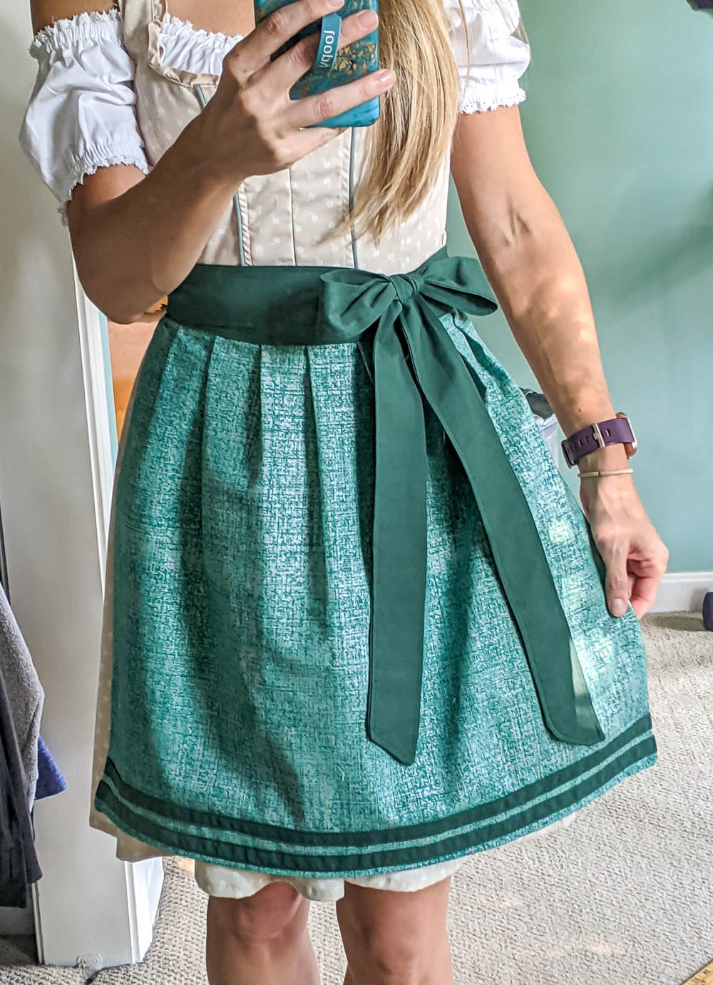 me showing off a teal apron I made