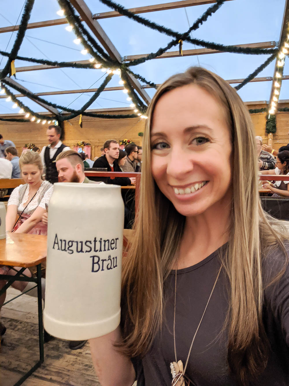 me holding a ceramic stein of beer