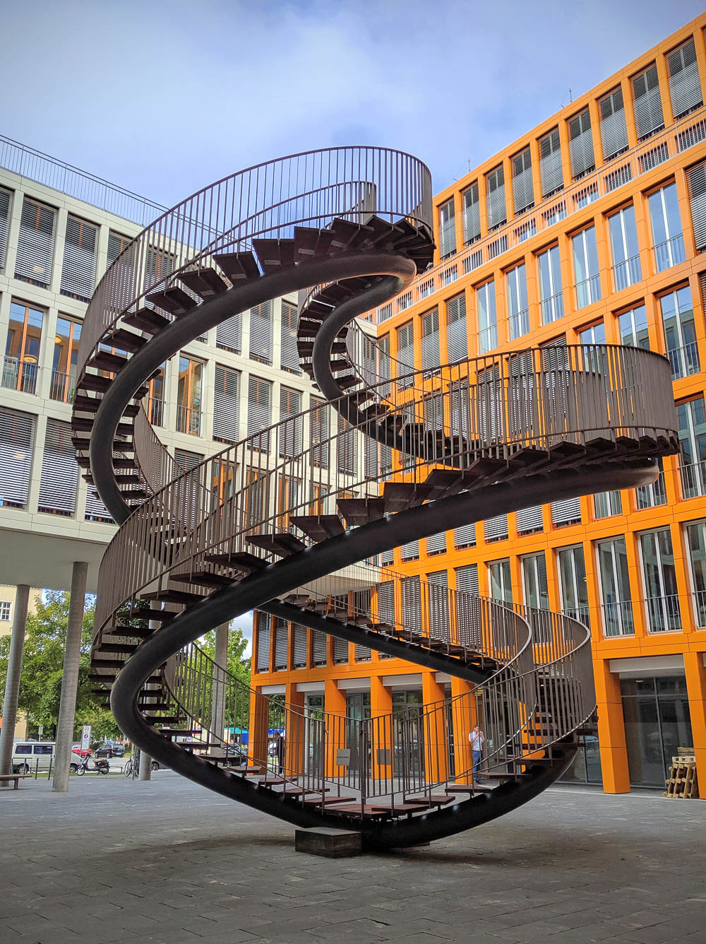 giant staircase to nowhere in front of an orange office building